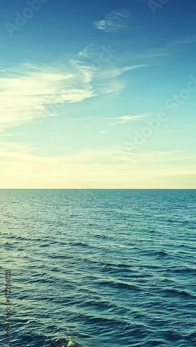 Blue sky and sea water surface, horizon, vertical phone wallpaper