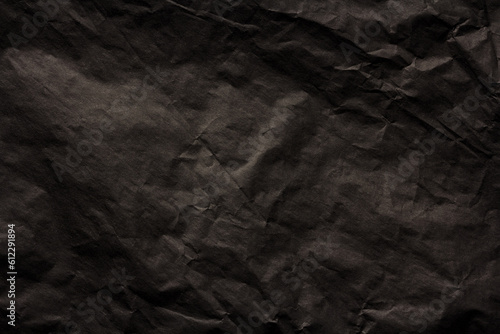 Black crumpled paper texture background..