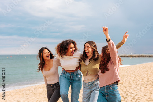 Diverse young women having fun on beach.