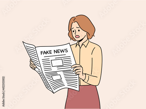 Newspaper with fake news in hands of woman reading false information from reporters using propaganda techniques to intimidate readers. Girl with newspaper with fake news frightened opens mouth