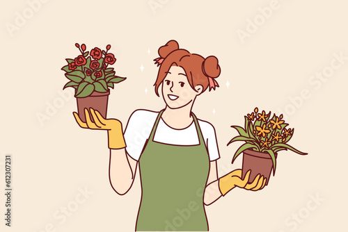 Woman florist with flowers in pots offers to purchase home plants to decorate interior of apartment. Happy girl in apron works as florist or gardener and owns own business and greenhouse