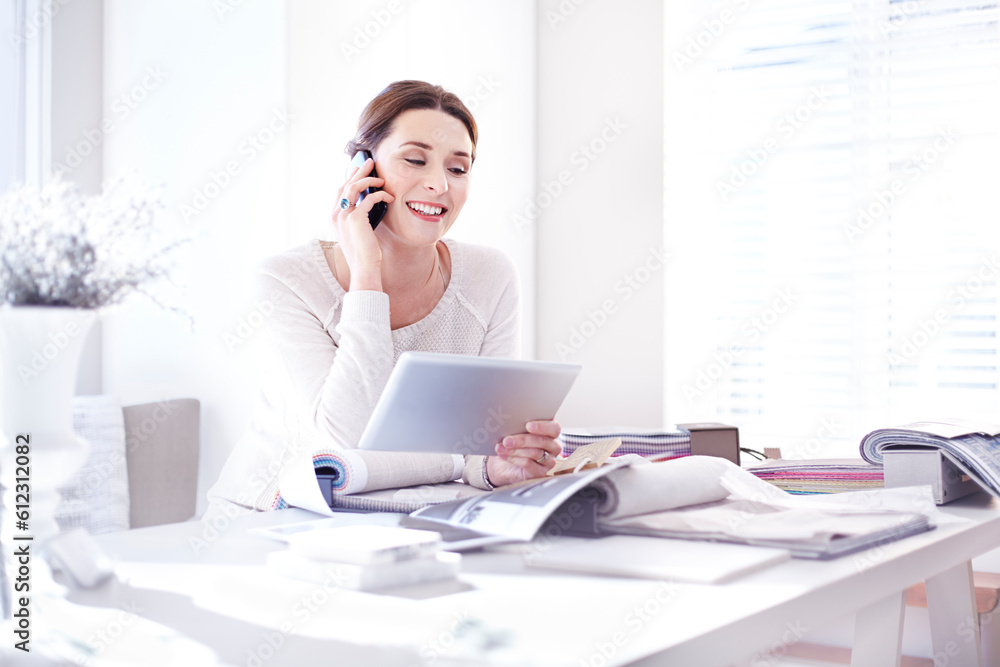 Interior designer talking on cell phone using digital tablet in office swatches Interior designer talking on cell phone using digital tablet in office swatches