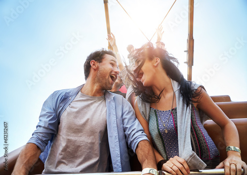 Photography Exhilarated young couple on amusement park ride