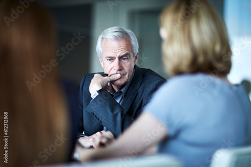 Valokuvatapetti Serious senior businessman looking down in meeting