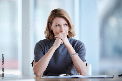 Pensive businesswoman looking away in conference room