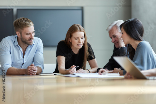 Slika na platnu Business people reviewing paperwork in meeting