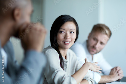 Businesswoman gesturing and talking in meeting