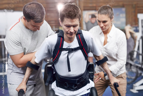 Physical therapists guiding man walking