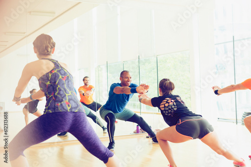 Fitness instructor leading exercise class