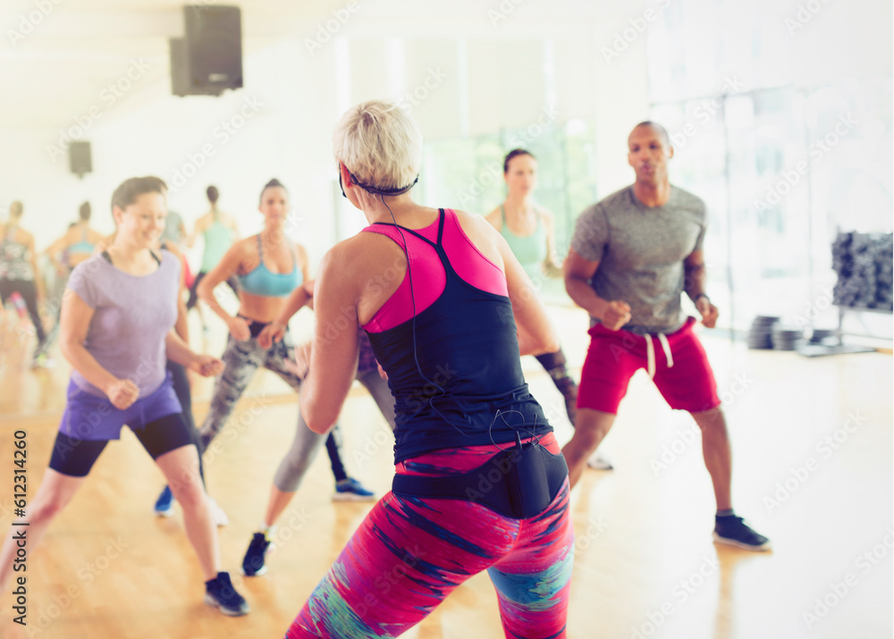 Fitness instructor leading aerobics class Fitness instructor leading aerobics class