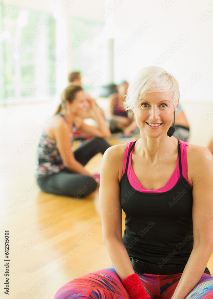Fototapeta premium Portrait smiling fitness instructor with headset