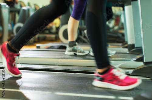 Woman‚Äôs legs running on treadmill at gym © KOTO