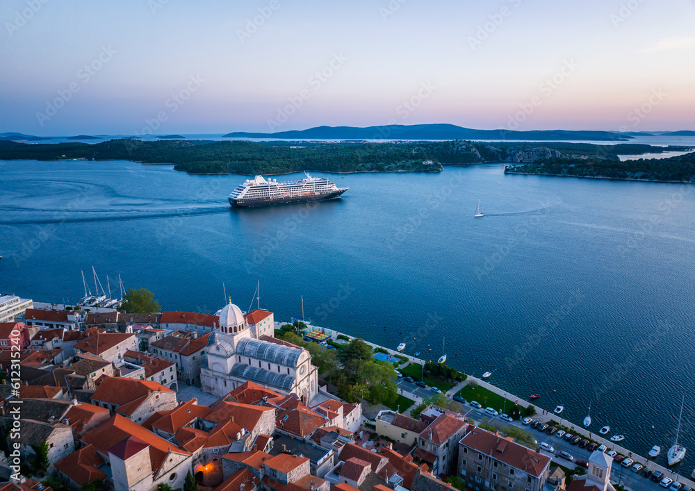 Amazing evening view with a cruise ship leaving the port of the picturesque town of Shibenik in Croatia.
