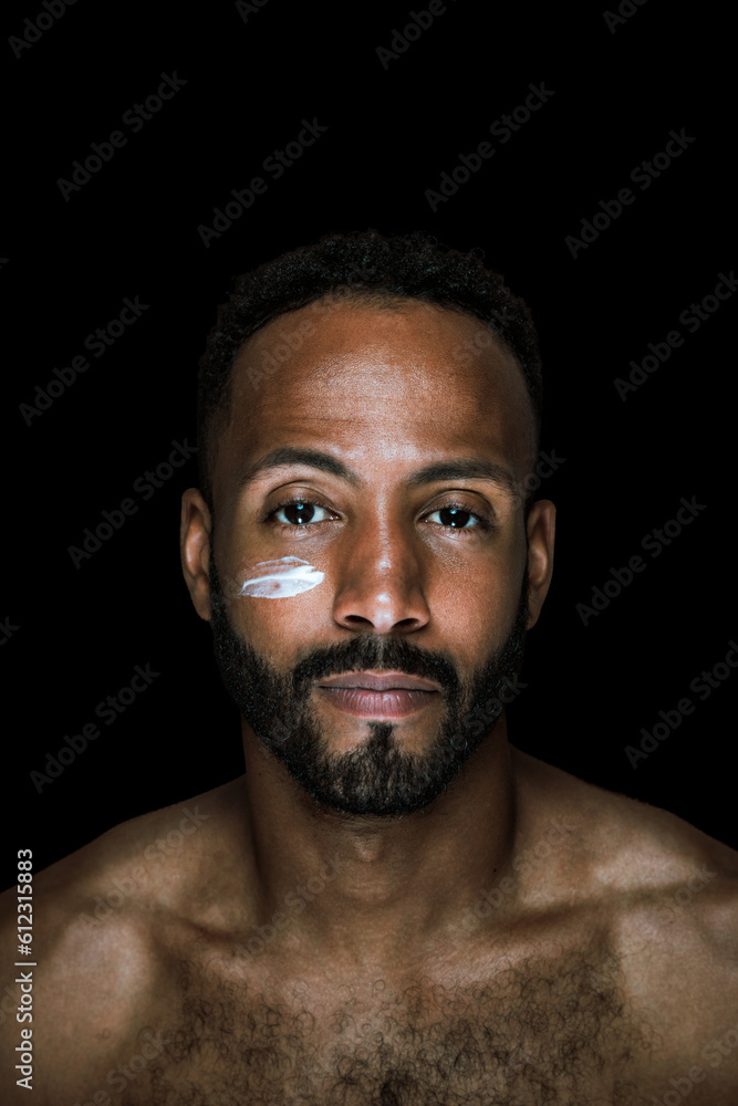 Fototapeta premium Image of a young man taking care of his skin