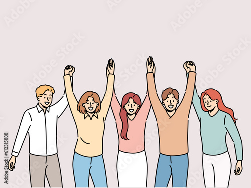 Friendly team holding hands and smiling for concept of successful collaboration to achieve ambitious goals. Team of students or colleagues from men and women rejoice at completion of joint project