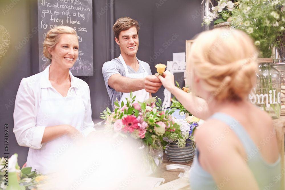 Florist giving woman rose in flower shop Florist giving woman rose in flower shop