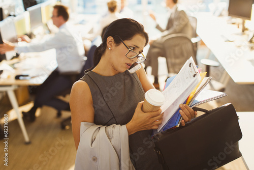 Stressed businesswoman struggling to multitask in office photo