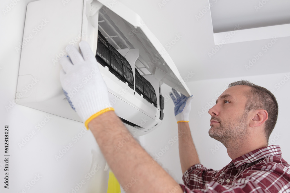 Service guy cleaning and maintaining air condition unit. Service guy cleaning and maintaining air condition unit.