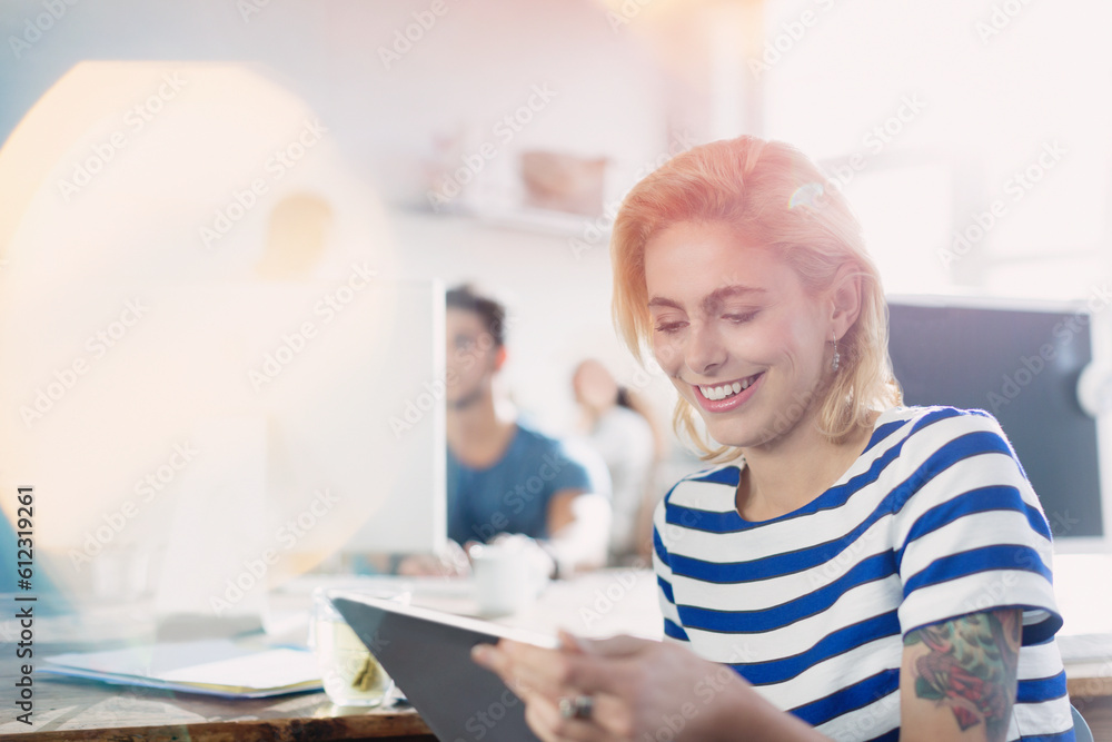 Smiling creative young businesswoman using digital tablet Smiling creative young businesswoman using digital tablet