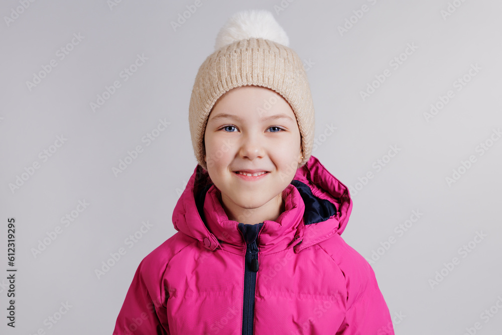 Little girl in pink winter jacket and knitted hat Little girl in pink winter jacket and knitted hat