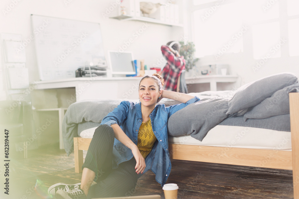 Female college student relaxing on bedroom floor - obrazy, fototapety, plakaty 