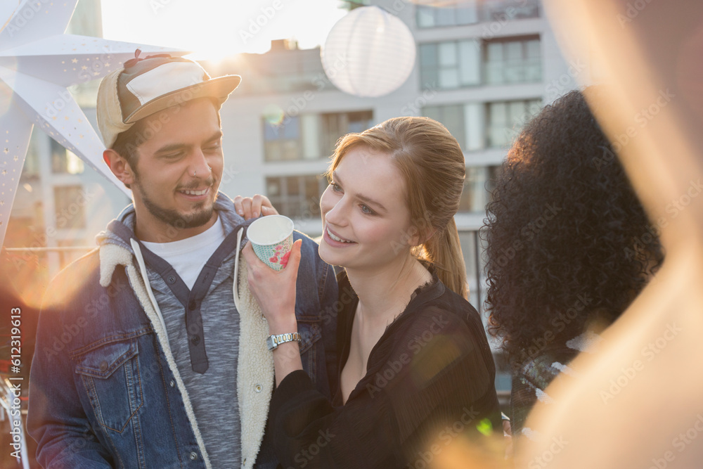 Young couple drinking and enjoying rooftop party Young couple drinking and enjoying rooftop party