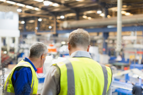 Supervisor and worker in steel factory