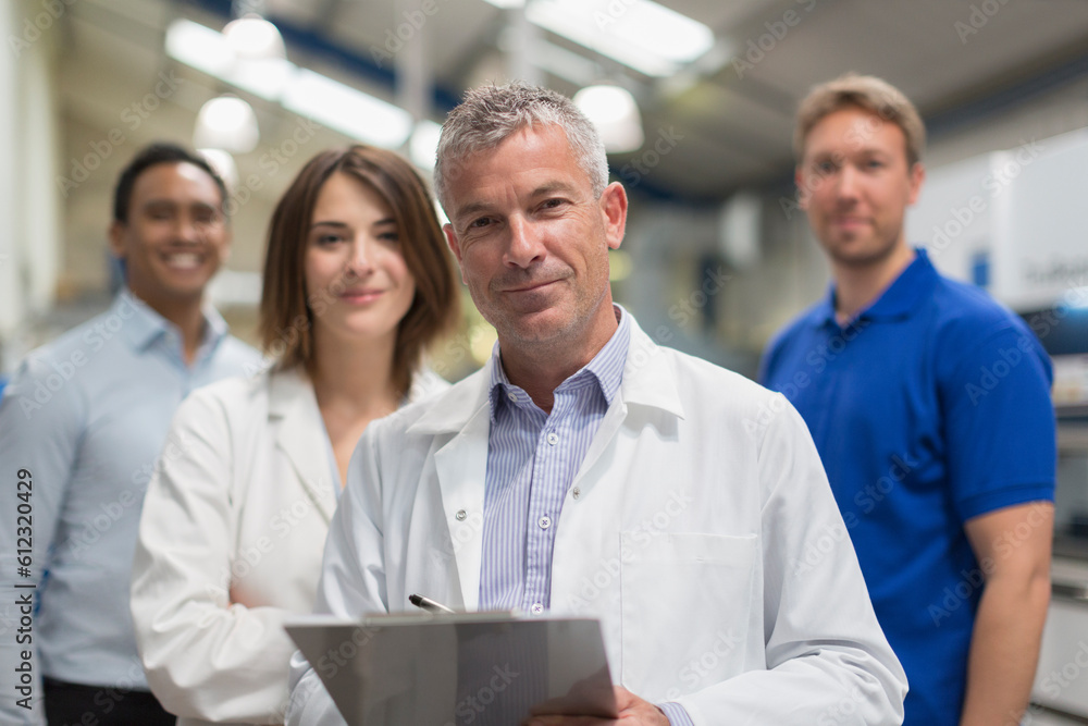 Portrait smiling engineer team in steel factory Portrait smiling engineer team in steel factory