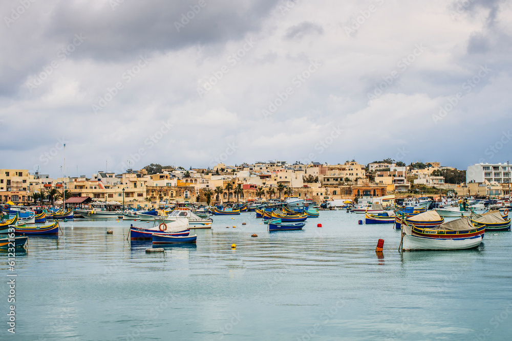 Boats mooring outside waterfront town, Marsaxlokk, Malta