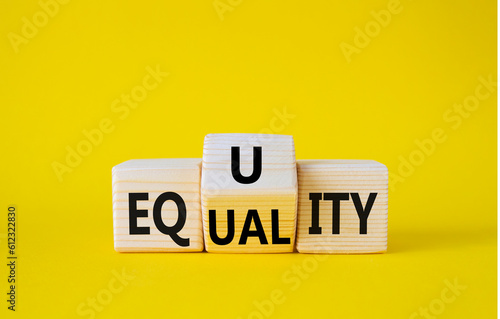 Equity and Equality symbol. Wooden cubes with words Equality and Equity. Beautiful yellow background. Equity and Equality and business concept. Copy space