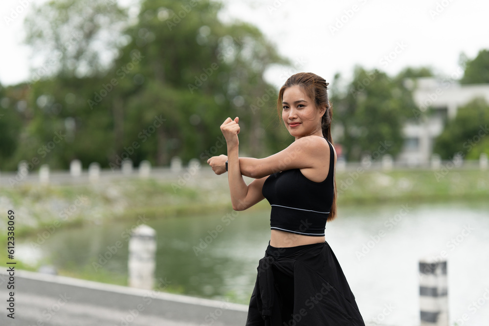 Healthy Asian woman is warm up before jogging outdoor. Fitness girl running. Female exercising at outdoor park
