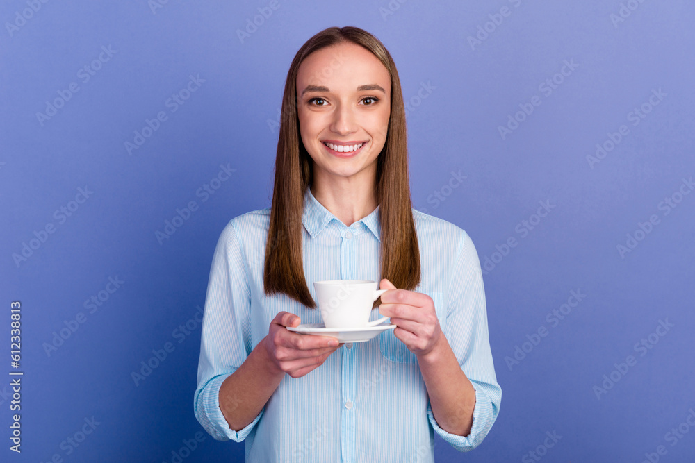 Portrait of agent girl holding in hands drinking latte isolated on blue color background Portrait of agent girl holding in hands drinking latte isolated on blue color background
