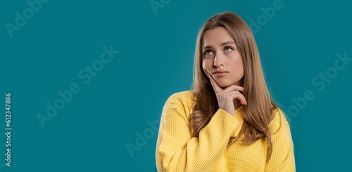 Thinking around woman on blue background. Puzzled lady looking answer.Copy space