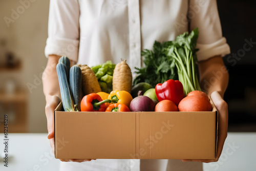 Convenient Grocery Delivery: Woman Excitedly Receives Fresh Vegetable Box photo