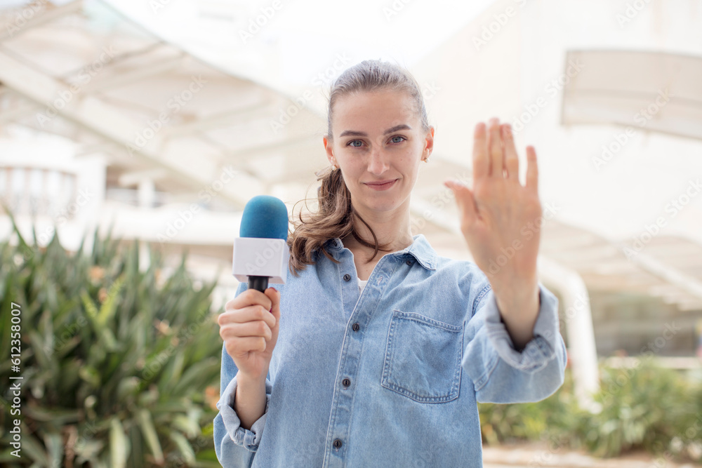 looking serious showing open palm making stop gesture. presenter with a microphone concept looking serious showing open palm making stop gesture. presenter with a microphone concept