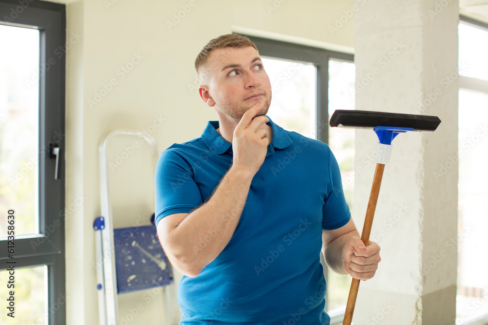smiling with a happy, confident expression with hand on chin. windows washer smiling with a happy, confident expression with hand on chin. windows washer
