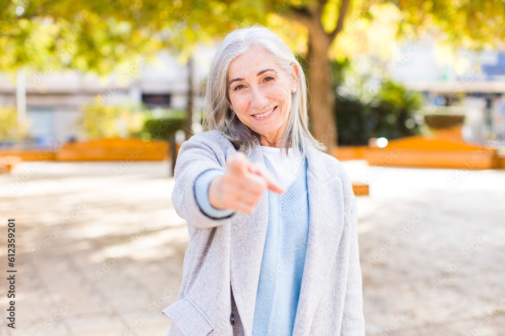 senior retired pretty white hair woman pointing at camera with a satisfied, confident, friendly smile, choosing you senior retired pretty white hair woman pointing at camera with a satisfied, confident, friendly smile, choosing you