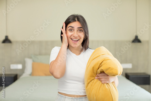 young woman feeling happy and astonished at something unbelievable. nightwear concept