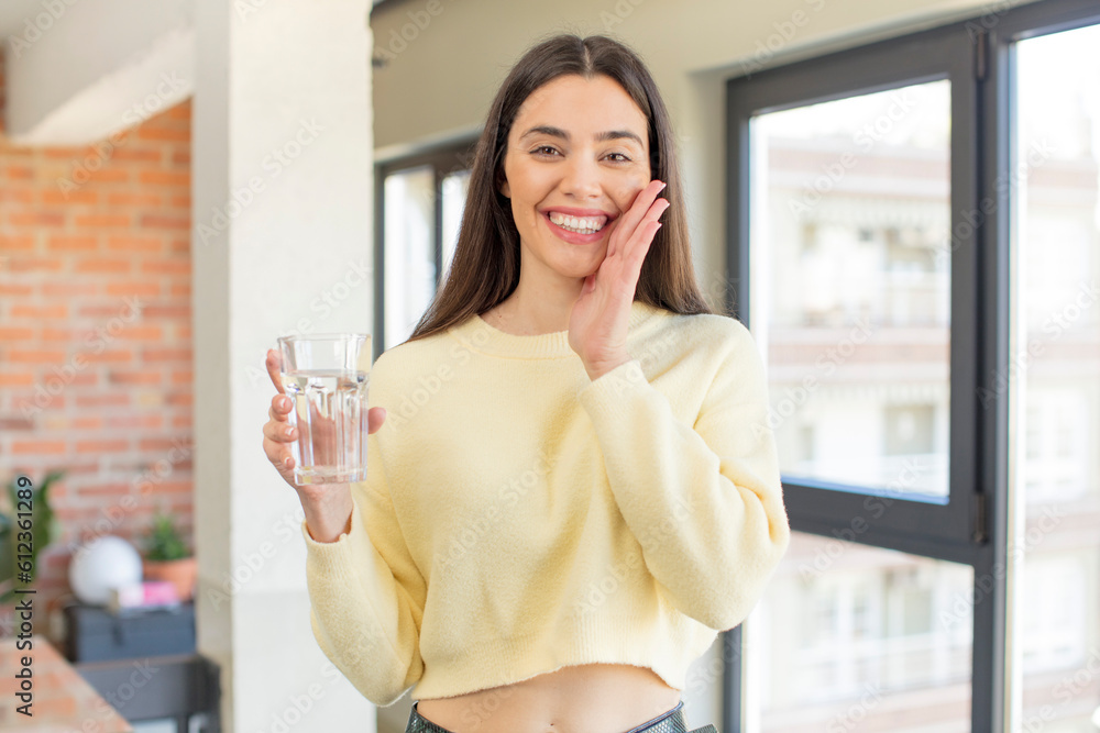 pretty young model feeling happy and astonished at something unbelievable. water glass concept