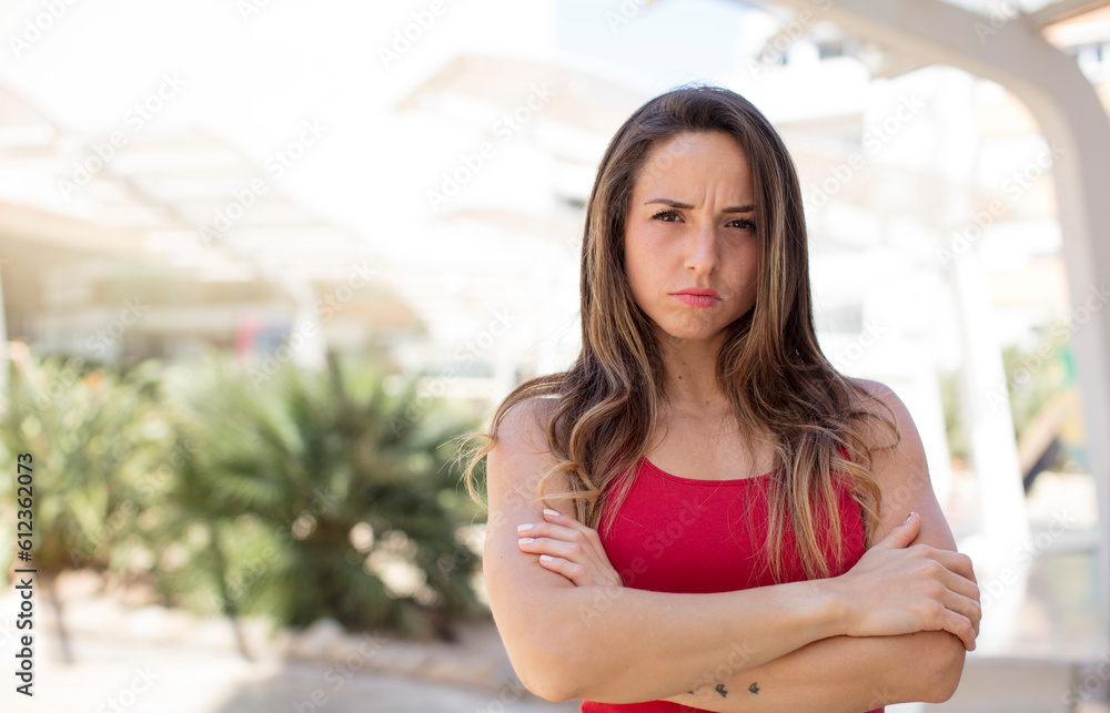 pretty woman feeling displeased and disappointed, looking serious, annoyed and angry with crossed arms