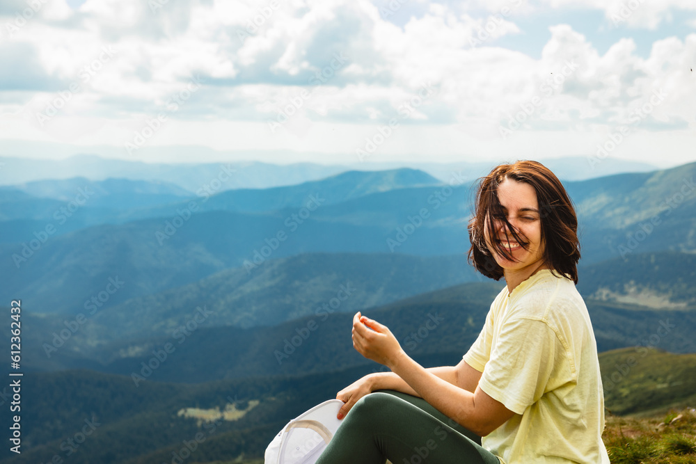 Smiling woman on the top of a mountain