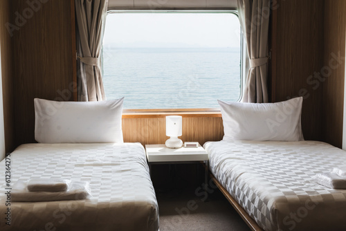 Bedroom with interior of double passenger cabin ferry ship with ocean view.