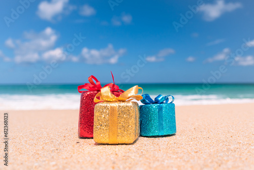 Gift boxes on sand with summer beach background.