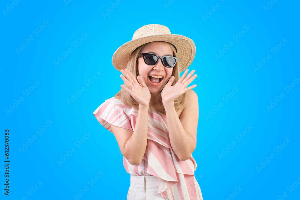 Asian woman happy feeling and walking or jumping with suitcase isolated on blue background, Tourist girl having cheerful holiday trip concept