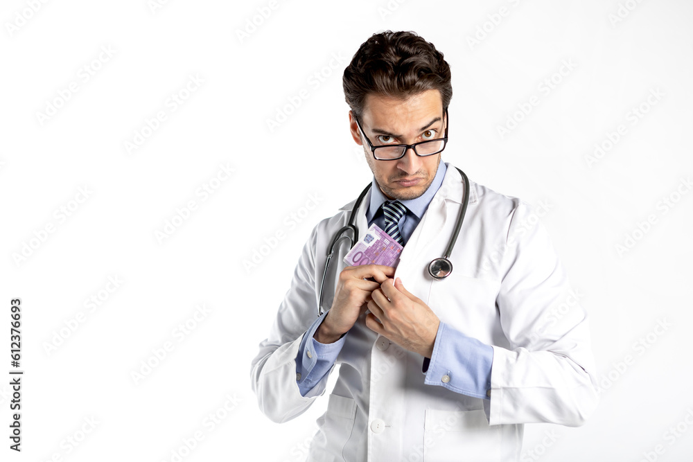 Funny and cunning doctor holding pack of money isolated on white background. Corruption, bribe and high salary concept Funny and cunning doctor holding pack of money isolated on white background. Corruption, bribe and high salary concept