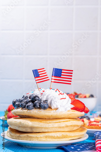 Holiday 4th of July breakfast pancakes, battercakes with whipped cream and berries like american flag. Homemade Patriotic sweet brunch or snack food, idea for party treat and desserts photo