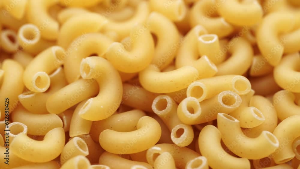Background of Uncooked Noodles that Slowly Rotating. Texture of Dry Vermicelli Turning Around. Raw Pasta. Bunch of raw pasta spins in a circle Background of Uncooked Noodles that Slowly Rotating. Texture of Dry Vermicelli Turning Around. Raw Pasta. Bunch of raw pasta spins in a circle