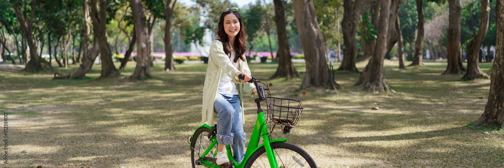 Women riding bicycle with having fun to relaxation and exercise for healthy lifestyle in the park Women riding bicycle with having fun to relaxation and exercise for healthy lifestyle in the park