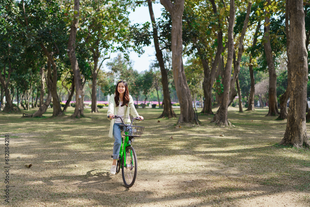 Women riding bicycle with having fun to relaxation and exercise for healthy lifestyle in the park Women riding bicycle with having fun to relaxation and exercise for healthy lifestyle in the park