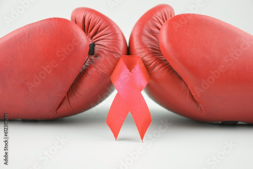 Red ribbon with boxing gloves, wrestling symbol.